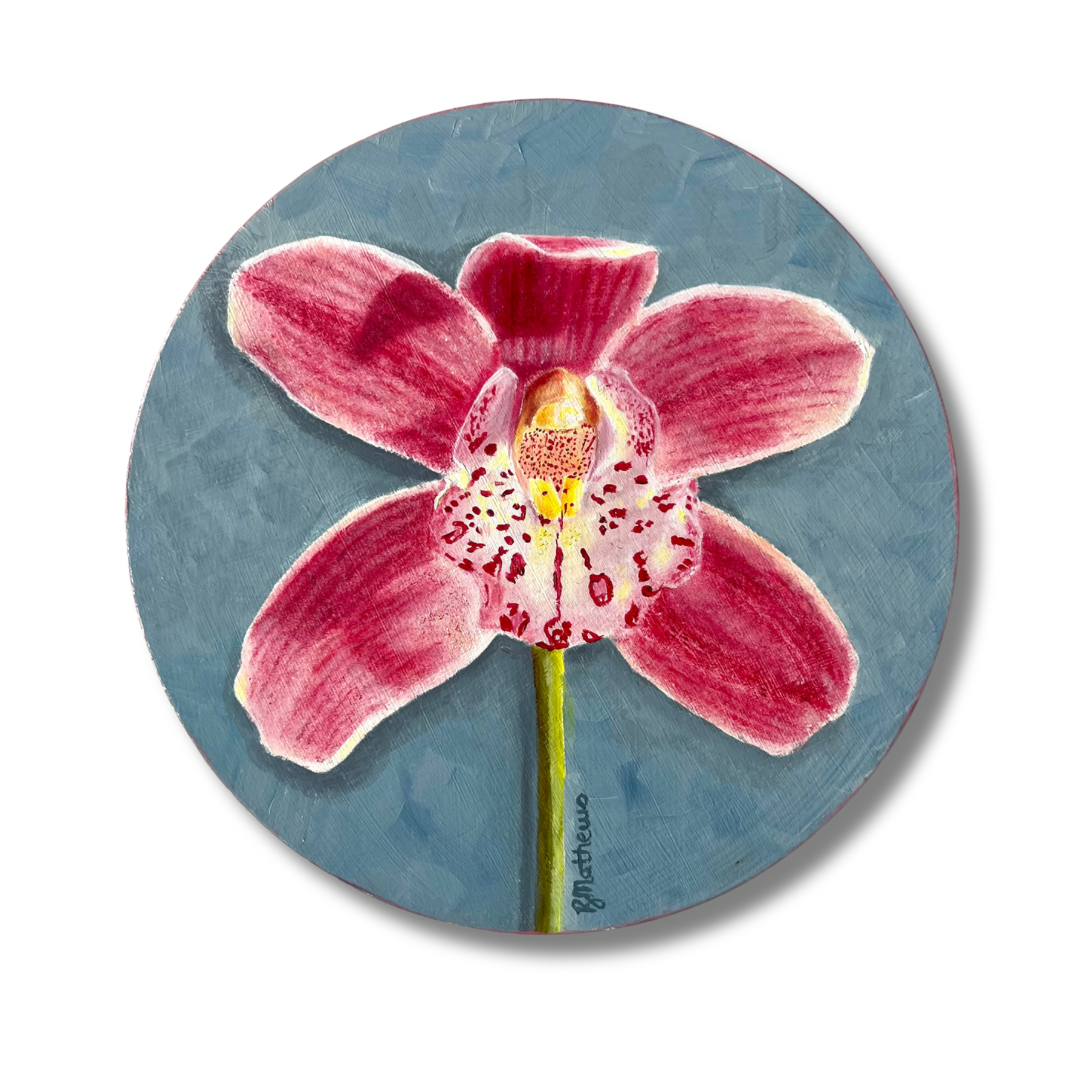 Circular artwork of a pink orchid on a blue background