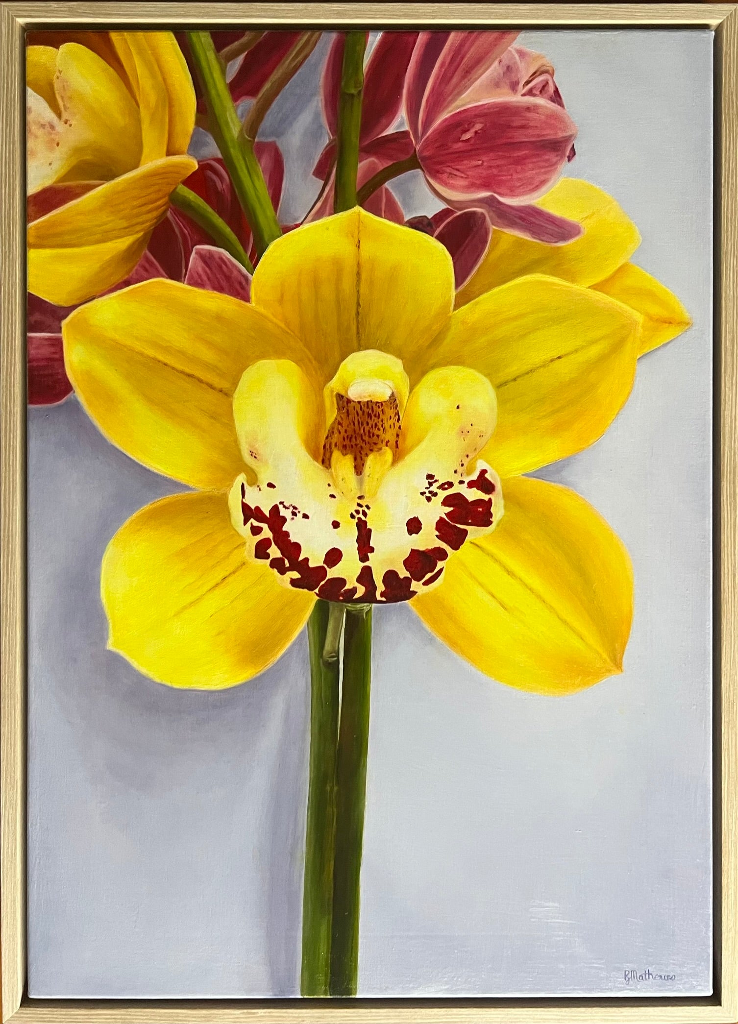 Framed artwork of a yellow orchid with red spots on a light gray background
